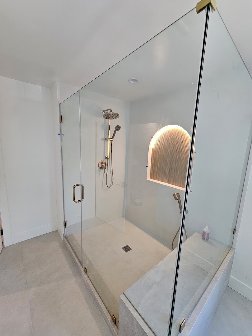 Floating double vanity with dual undermount sinks and brushed bronze faucets — A-Craft Plumbing remodel work
