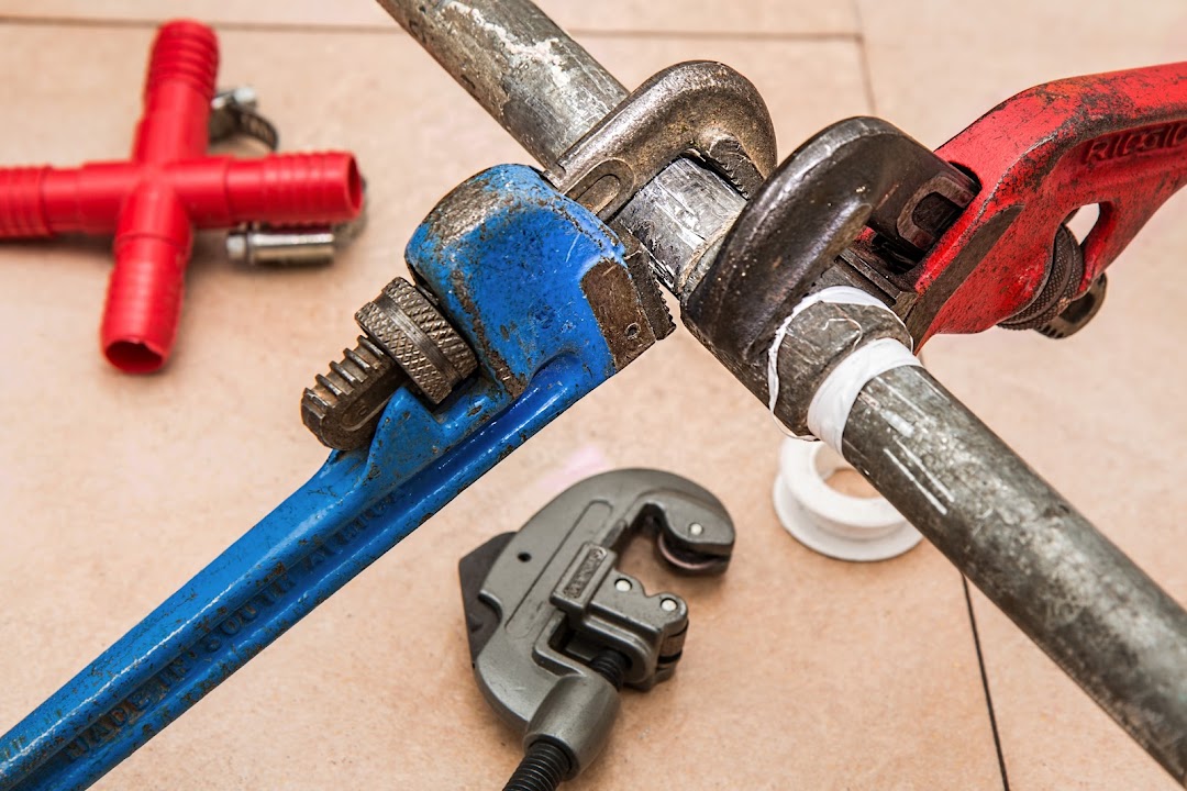 Plumber inspecting water line connection
