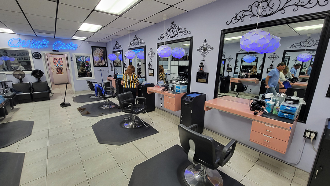 Barber at work inside Quick Cuts