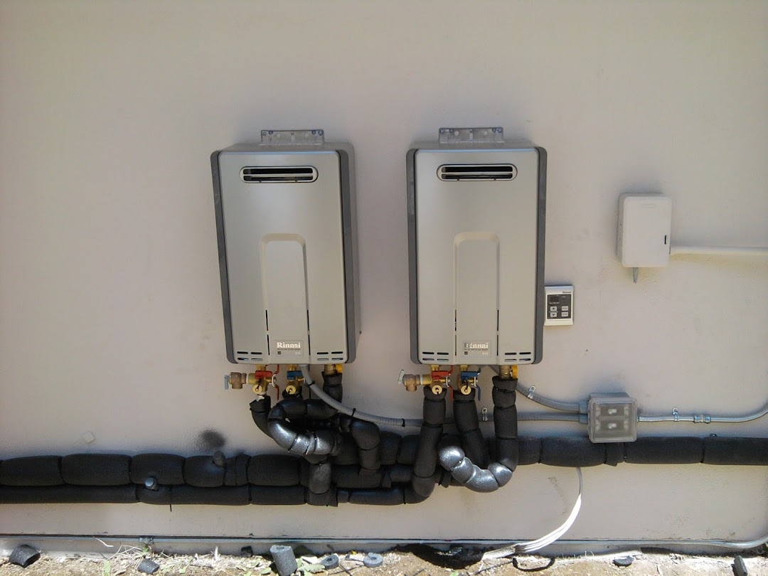 Finished water heater installation with clean pipe routing