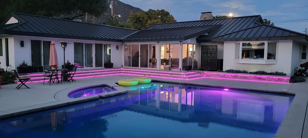 Outdoor LED landscape lighting installation — backyard pool at night