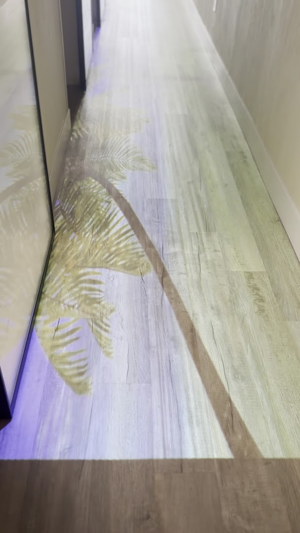 Zen Scalp Spa hallway with atmospheric tropical projection on the floor